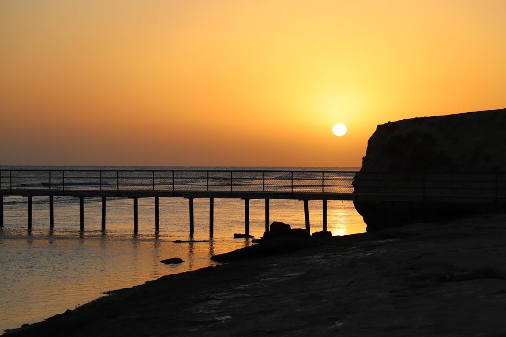 Sunrise over the Red Sea Photo by Wolfgang Gerth via Pixabay.  The weather is hot in summer tempered by a sea breeze and winter day time temperatures are usually comfortably warm. 