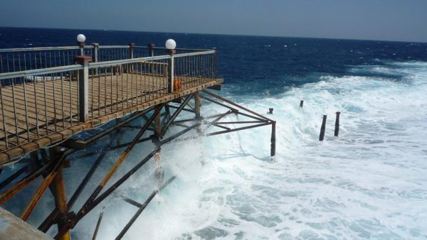 Dreams Beach Resort jetty battered by strong waves. during windy weather at Marsa Alam.