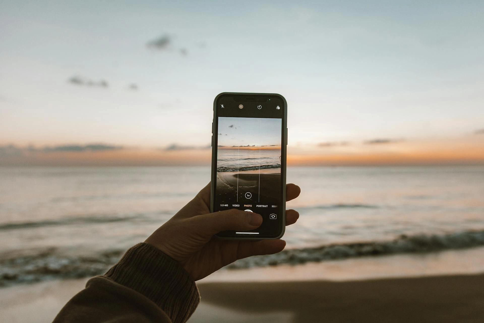 Does your hotel WiFi reach the beach?   Photo of person photographing the sea by Roman Odintsov via Pexels.com. 