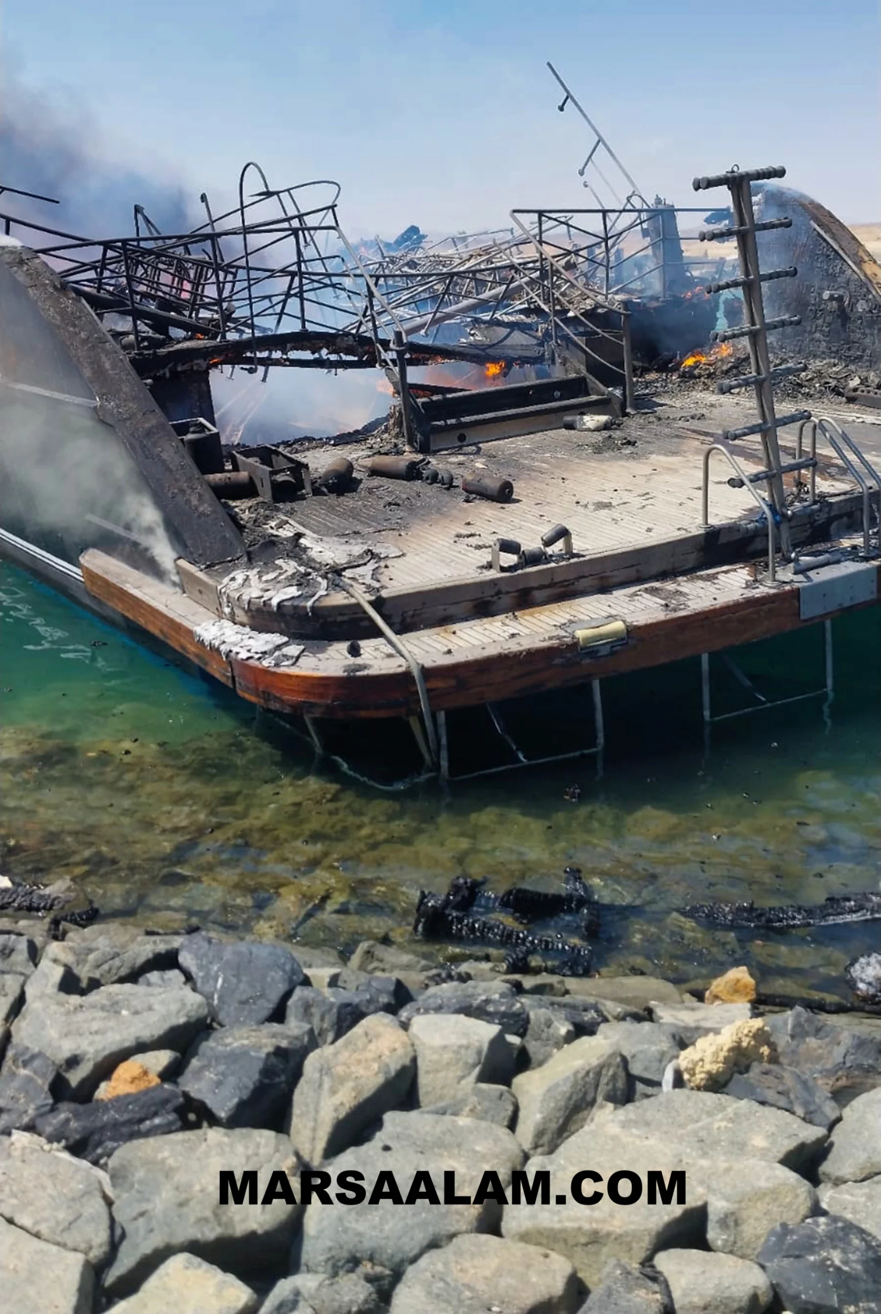 A photograph showing the damage to the dive boat by the time the fire had been nearly extinguished.