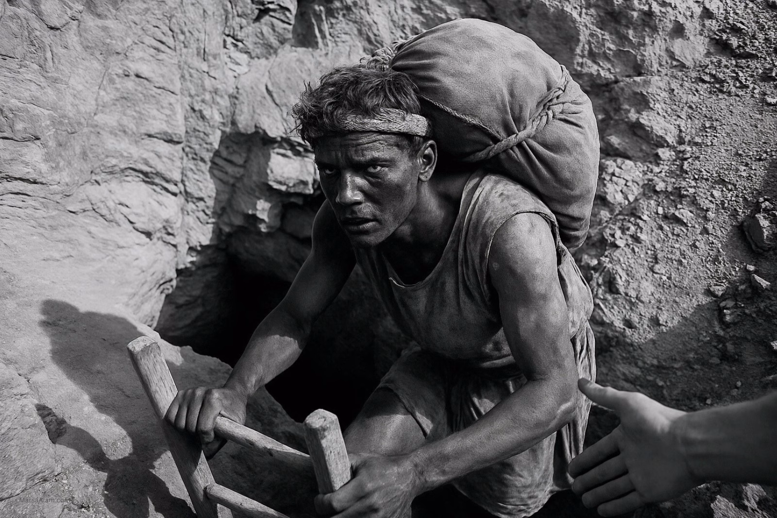 AI Image of Roman era miner exiting a deep emerald mine shaft at Sikait. 