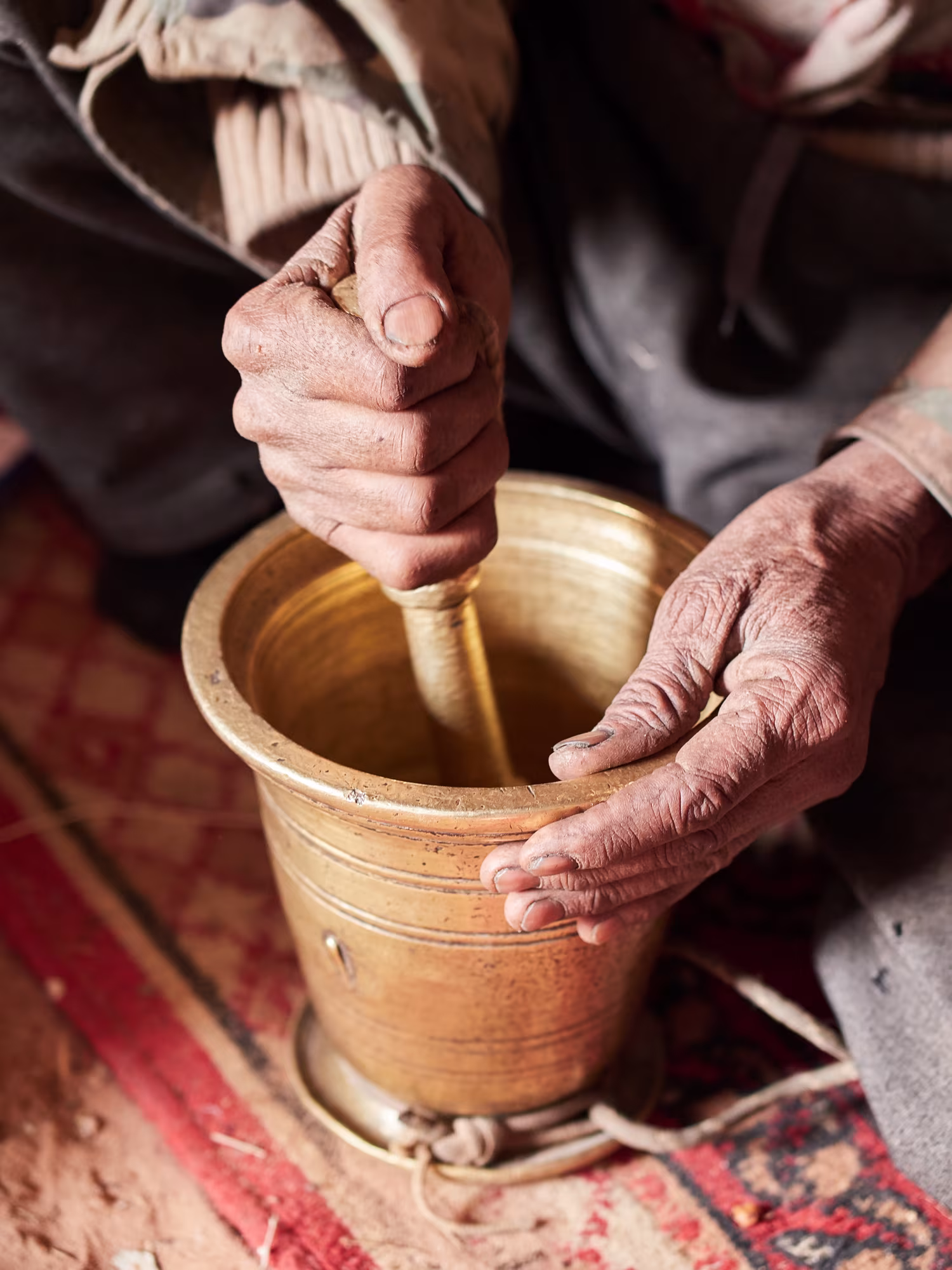 Grinding the coffee beans. 
ID 172197178 © Thecriss |Dreamstime.com  Original caption: "Bedouin grinding coffee beans for traditional Bedouin coffee with spices."  Retrieved on 2 November 2025. 
