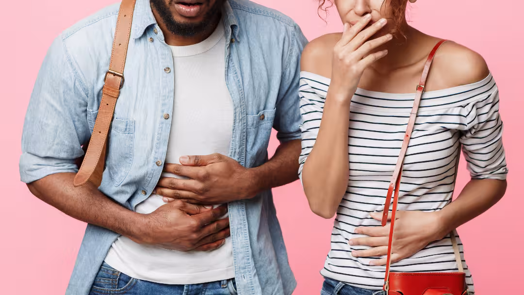 A photograph of a man and woman who seem to either have stomach ache and/or feel sick. ID 141032774 © Prostockstudio | Dreamstime.com